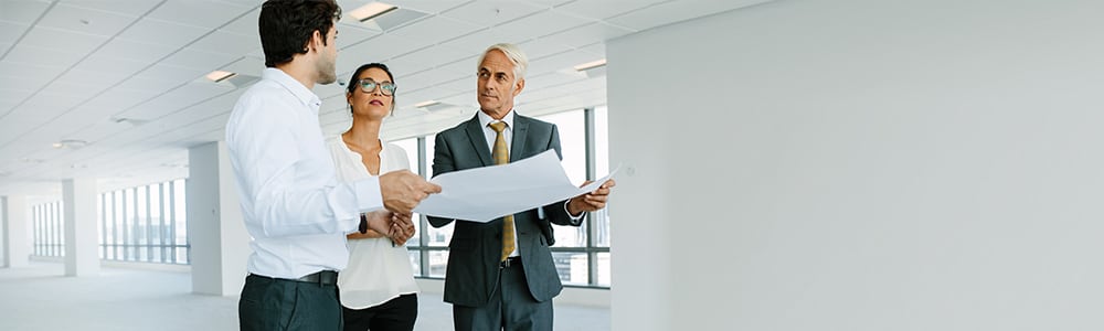 A real estate broker discusses plans with his chiropractor clients.