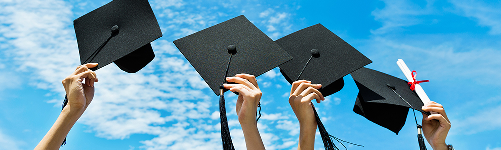 Chiropractic graduates throw their hats into the air