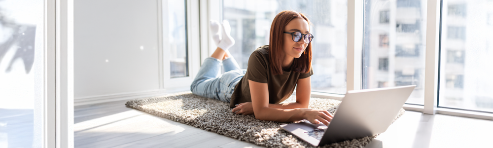 Woman on floor working on a laptop